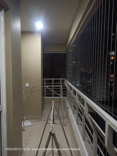 Anti bird net fitted along a covered walkway at night