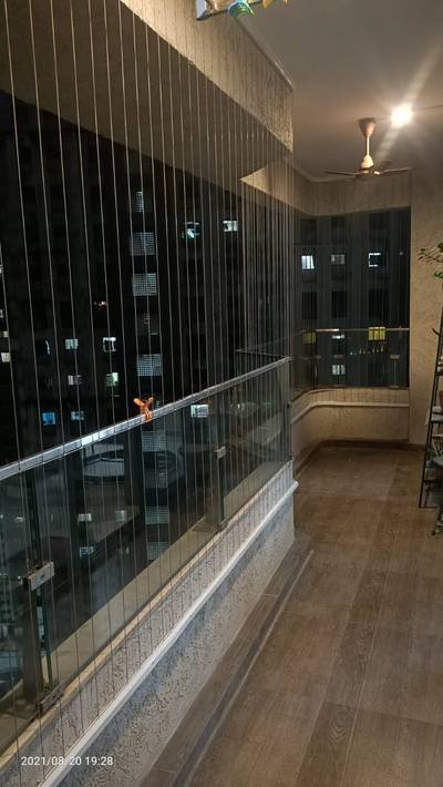 Anti bird net along an interior corridor opening in the evening