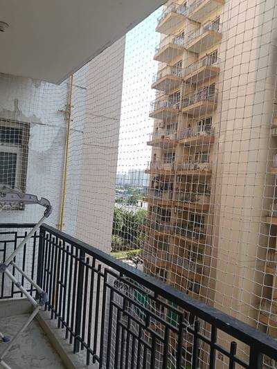 Pigeon net on a balcony facing a high-rise housing society