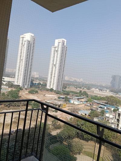 Pigeon net fitted across a balcony overlooking residential towers