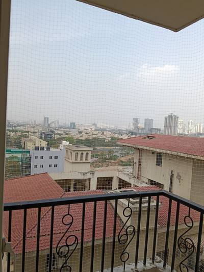 Pigeon net installed on a balcony overlooking low-rise homes