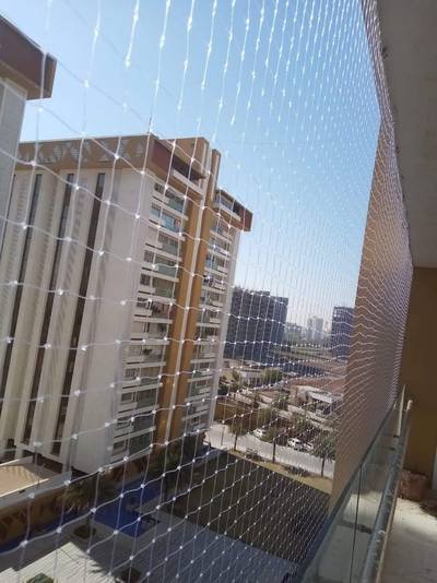 Balcony safety net with a city high-rise outlook