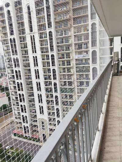 Balcony safety net facing tall residential towers