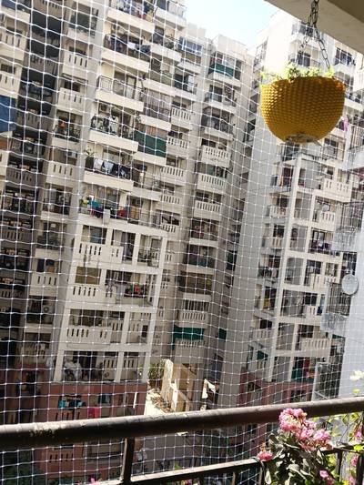 Balcony safety net installed on a high-rise apartment balcony railing