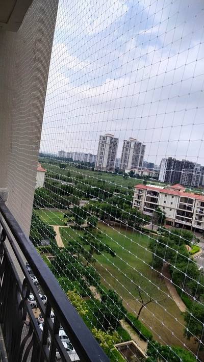Balcony safety net overlooking a green landscape