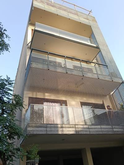 Bird net covering multiple floors of a building exterior