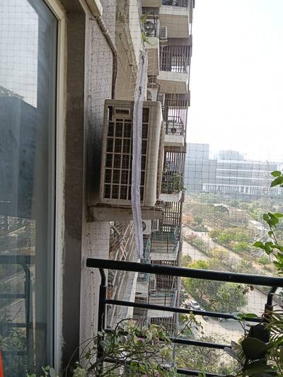 Pigeon net installed over a residential window and grill