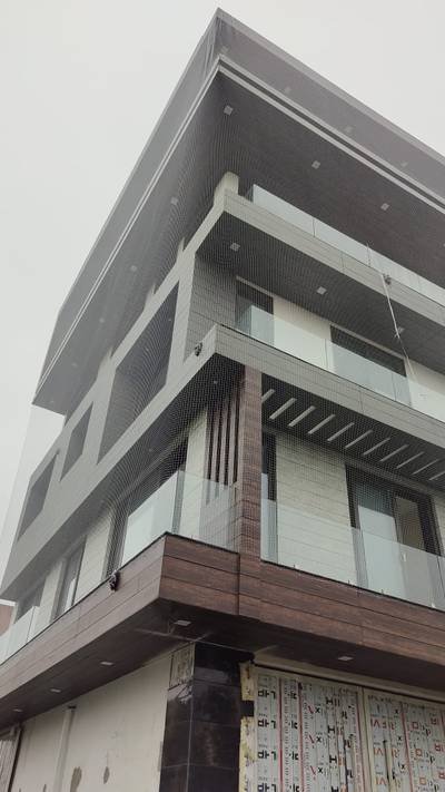 Pigeon protection net across a building elevation and balconies
