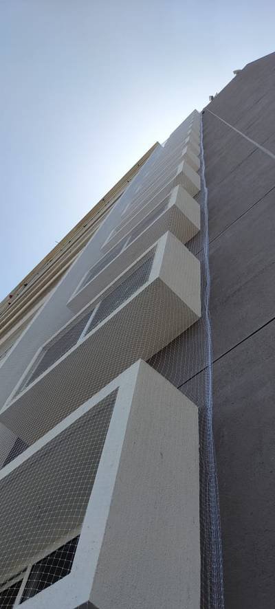 Netting wrapped around the corner elevation of a building