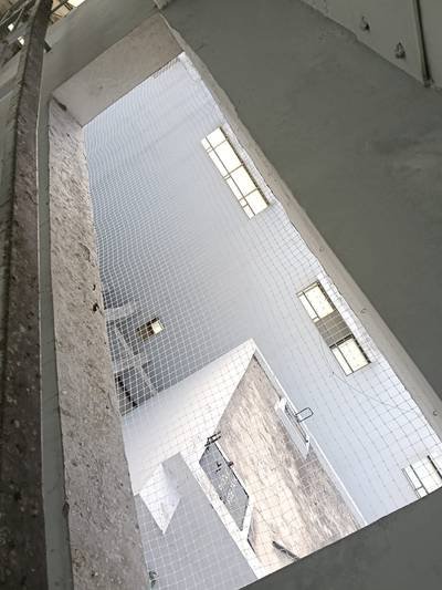 Pigeon protection net stretched across an internal courtyard light well